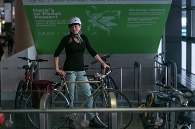 Jessica Brown stands with a bicycle in a Port of Seattle facility.